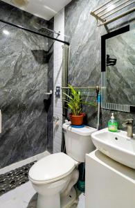 a bathroom with a toilet and a sink at Cityloft Guesthouse in Tagbilaran City +26 photos