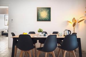 a dining room with a table and chairs at Zuara9Room Rimini in Rimini