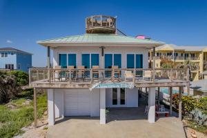 a house with a deck and a balcony at 'Little Latitude' High Tide - Oceanfront Home with Crow's Nest! in New Smyrna Beach