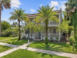 a house with palm trees in front of it at Casita Tropical l Walk to DT l Mins to Beach in Saint Augustine