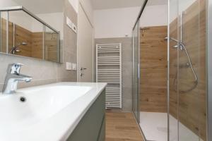 a bathroom with a sink and a shower at Casa Serena in Dolomiti Agordine in San Cipriano +18 photos