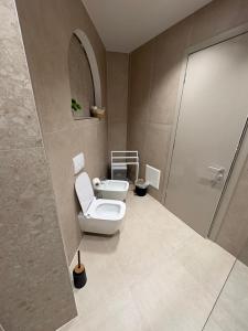 a bathroom with a toilet and a shower at Uzeiri Guest Hotel in Borsh