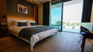 a bedroom with a bed and a large window at RUKA Hotel in Narlıdere