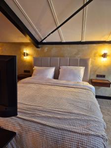 a bedroom with a large bed with white pillows at Maison Colombe, met airco in Oudesluis +42 photos