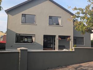 a house with a fence in front of it at Station Road Homestay in Castlebar