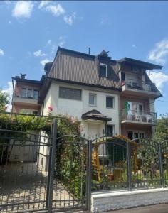 a house with a gate in front of it at Apartments Villa Sena in Sarajevo