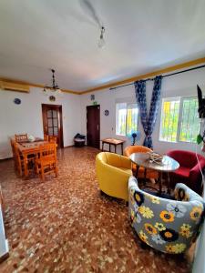 a living room with couches and a table at La Cabaña de la Cigarra in Almodóvar del Río