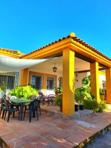an outdoor patio with a table and chairs at La Cabaña de la Cigarra in Almodóvar del Río