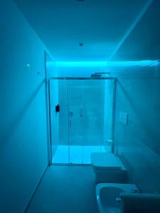 a bathroom with two toilets and a glass shower at Kupe Luxury Loft in SantʼAgata sui Due Golfi