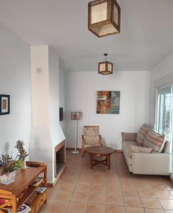 a living room with a couch and a fireplace at Hacienda Golf terraza con acceso directo a la piscina in Islantilla