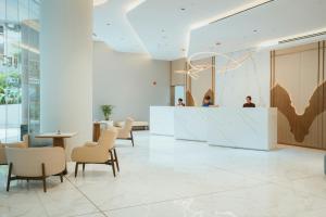 a lobby with a reception desk and chairs at Kandy Myst by Cinnamon in Kandy