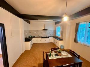 a kitchen and dining room with a table and chairs at Roy-al Homestay 1 in Shillong