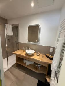 a bathroom with a sink and a shower at Les Chambres d'Hôtes du Château Eclosion in Saint-Paul-en-Jarez