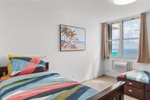 a bedroom with a bed and a window with the ocean at The Best View in Luquillo Beach Front View in Luquillo