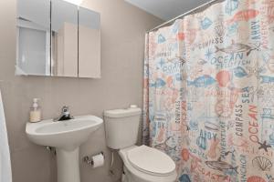 a bathroom with a sink and a toilet and a shower curtain at The Best View in Luquillo Beach Front View in Luquillo +32 photos
