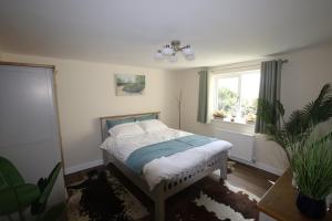 a bedroom with a bed and a window at The Rookery Sandside - Stylish luxury Home 