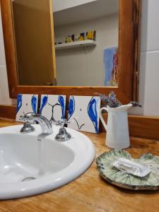 a bathroom counter with a sink and a mirror at Casa Arte - Casa Completa en Trelew in Trelew
