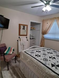 a bedroom with a bed and a ceiling fan at Carrousel Bed & Breakfast in Cayuga +13 photos