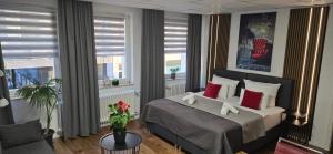 a bedroom with a bed with red pillows at City NOWA in Nuremberg