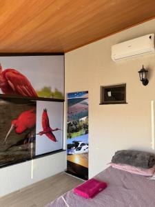 a bedroom with posters on the wall and a bed at Casa Lençóis Maranhenses in Barreirinhas