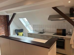 a kitchen with a sink and a counter top at Ferienwohnung Klosterblick Insel Malchow mit eigenen Bootsanleger in Malchow +7 photos