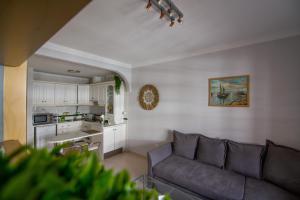 a living room with a couch and a kitchen at Bacon del Mar Apartment in Costa Del Silencio
