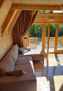 a living room with a couch and a bed at Grahovo Čelin Stream in Grahovo +5 photos
