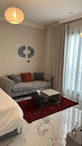 a living room with a couch and a coffee table at Modern Studio, Self-Entry, 2 min to Sea in Dammam +8 photos