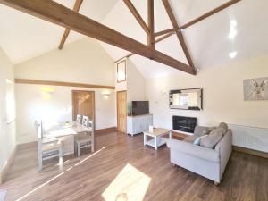 a living room with a couch and a table at Courtyard Hot Tub in Garton