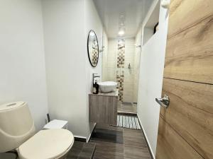 a bathroom with a toilet and a sink at Laureles Boutique Stay in Medellín +43 photos