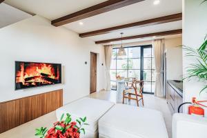 a living room with a couch and a fireplace at 1BR Balcony Pool Villa Near Seseh Beach in Munggu