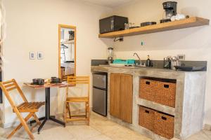a kitchen with a counter and a table at Xaman - Boutique Studios in Cancún