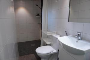 a white bathroom with a toilet and a sink at Near Santa Village with Free Parking in Rovaniemi +21 photos