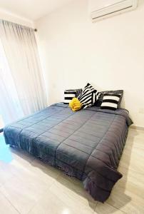 a bedroom with a bed with a blue comforter at Marina Cerritos de Lujo - Azul Cielo - 5 Albercas in Mazatlán +21 photos