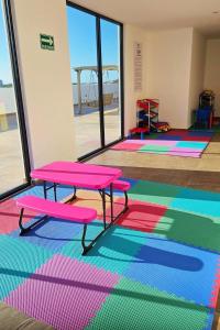 a room with a table and some colorful carpet at Marina Cerritos de Lujo - Azul Cielo - 5 Albercas in Mazatlán