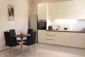 a kitchen with a table and chairs in a room at Stv Royal Appartments in Areopoli