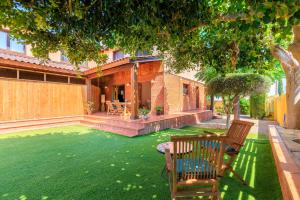 a house with a yard with green grass at Villa with private pool 3 minutes from the beach in Montroig