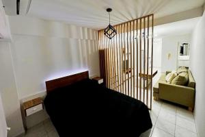 a bedroom with a bed and a couch at departamento 4 y 59 in La Plata
