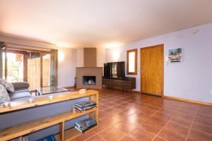 a living room with a couch and a fireplace at Villa with private pool 3 minutes from the beach in Montroig