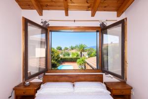 a bedroom with a bed and a large window at Villa with private pool 3 minutes from the beach in Montroig +47 photos