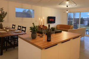 a kitchen with a table with wine glasses and candles at Maison de Standing 3 Chambres Parking Spacieux in Château-Gaillard