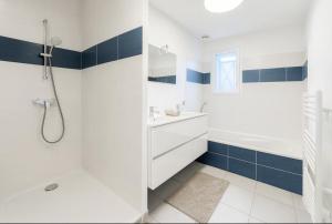 a bathroom with a tub and a sink and a shower at Maison de Standing 3 Chambres Parking Spacieux in Château-Gaillard +7 photos