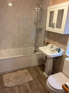 a bathroom with a sink and a shower and a toilet at Willow Cottage in Settrington +5 photos