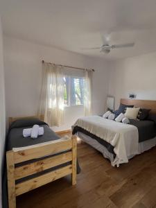 a bedroom with two beds and a window at Diez Pinos in Punta del Este +23 photos