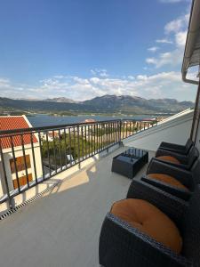 a balcony with chairs and a view of the water at Apartments Dream in Tivat