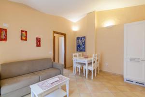 a living room with a couch and a table at Appartamento Mare Sardegna Porto San Paolo in Porto San Paolo