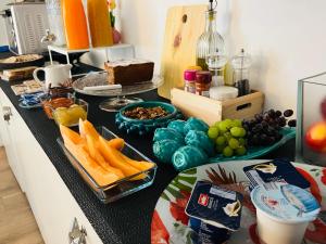 a kitchen counter with a bunch of food on it at B&B Il Bianco E Il Nero in Siracusa +28 photos