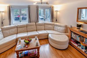 a living room with a couch and a table at Beachside Court in Porthtowan