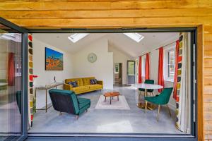 a living room with a couch and a table at Haons in Biddenden