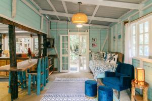 a blue room with a bed and a table at Casa Olas Bluff Beach in Bocas Town